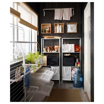 Black HYLLIS storage shelves with items & drying clothes by window