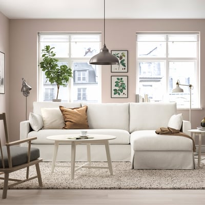 Cosy living room with HYLTARP sofa, coffee table, & plant.
