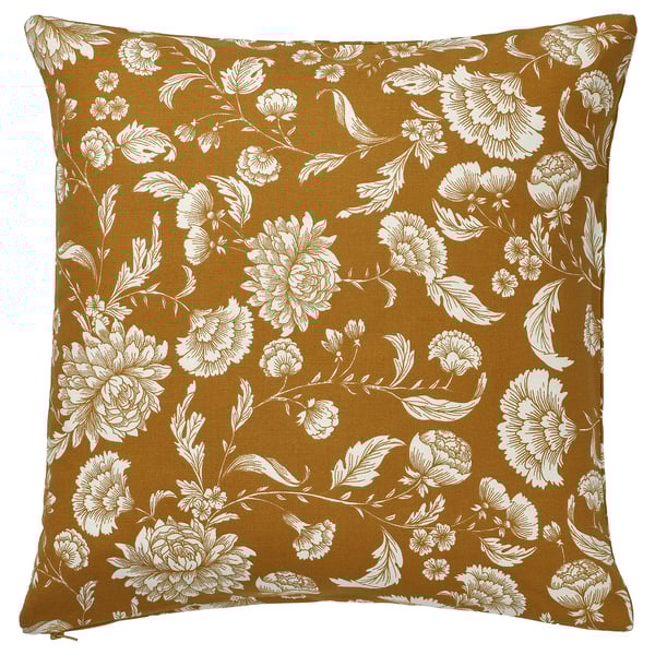 Square mustard yellow throw pillow with white floral pattern.