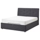 IDANÄS dark grey upholstered bed with tufted headboard and white mattress.