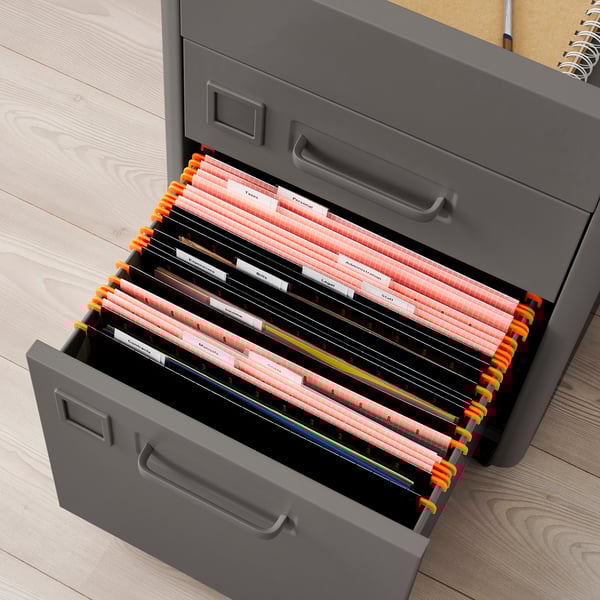 Open grey filing cabinet with orange hanging folders, labelled and organised, on wheels.