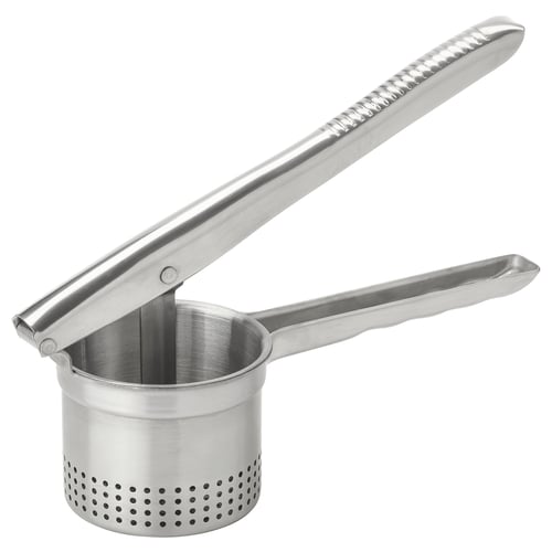 An IDEALISK stainless steel potato press, designed with two handles and a cylindrical mesh basket for efficient mashing of potatoes.