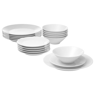 White IKEA 365+ dinnerware, including plates and bowls, arranged neatly. The pieces are simple, durable, and stackable, perfect for everyday use.