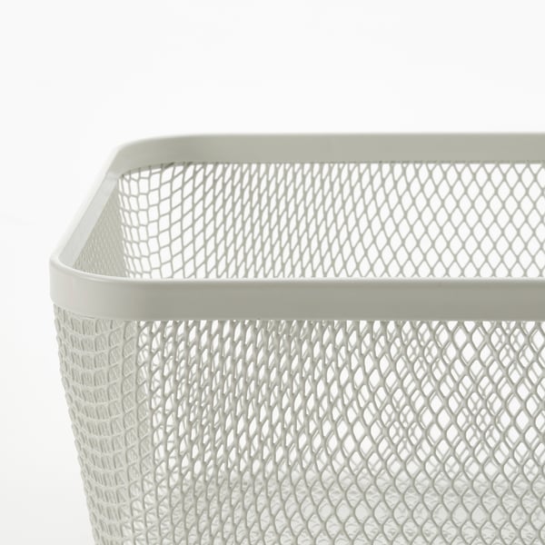 White mesh storage basket with diamond pattern, sturdy edges, stands alone. Ideal for kitchen organisation.