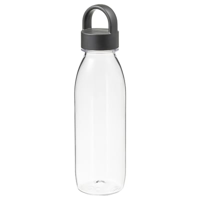 An IKEA 365+ transparent water bottle with a dark grey handle lid. It stands upright, shaped like a classic bottle with a sturdy, practical design.