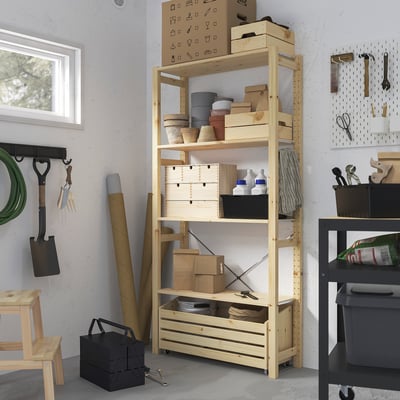 Wooden IVAR storage unit with boxes and tools, positioned centrally, taller than surrounding items.