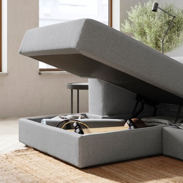 JÄTTEBO grey sofa with storage open, showing cushions and mechanism. Modern design with soft fabric.