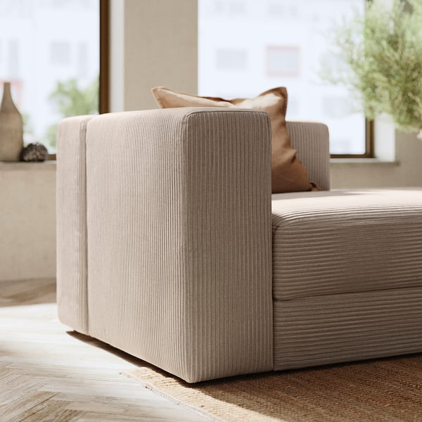 Modern JÄTTEBO sofa in beige, corduroy fabric with clean lines, plush cushions, and a chaise lounge end.