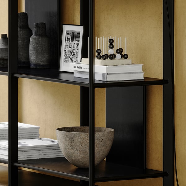 Black modern shelf with bamboo, steel, & aluminium materials. Displays vases & books, sleek & minimalist design.