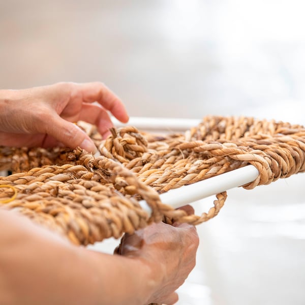 Handcrafted woven banana fibre stool, showcasing intricate detail and quality craftsmanship.