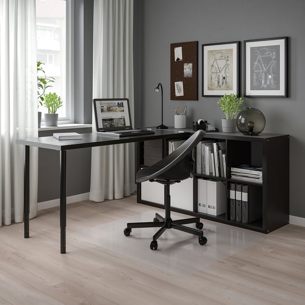 Image shows a modern home office with KALLAX black shelves. It includes a black desk with a laptop, chair, books, and decor.
