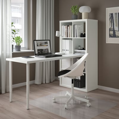 White KALLAX desk with chair, laptop, books, and shelf.