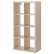 An empty, light-colored, wooden KALLAX shelving unit with a rectangular shape and clean lines.