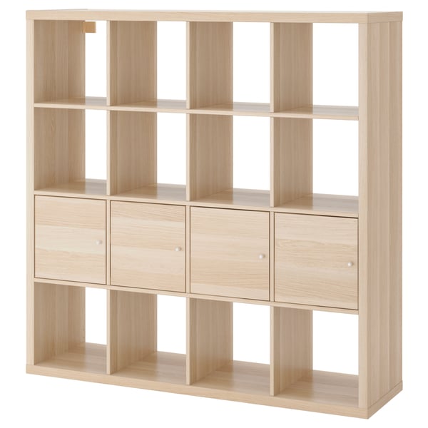 A light wooden KALLAX shelving unit with clean lines, featuring both open compartments and hidden storage inserts.