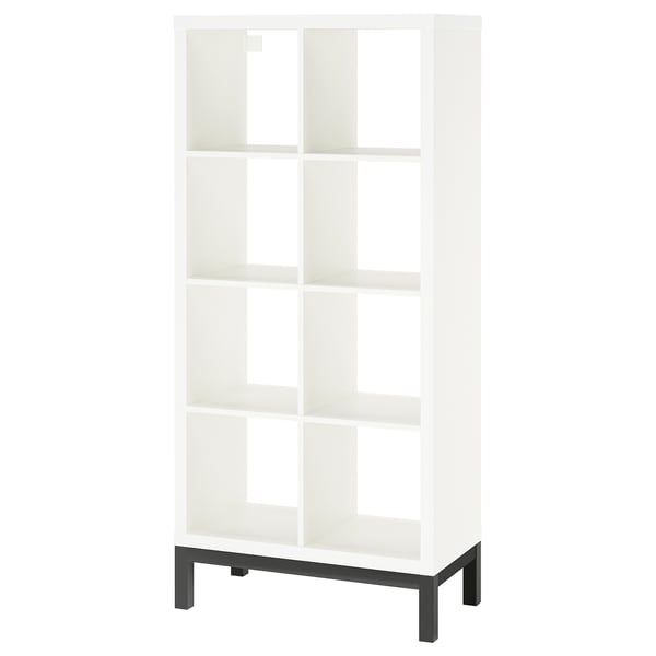 A white KALLAX shelving unit with a black metal base, featuring open compartments for storage.