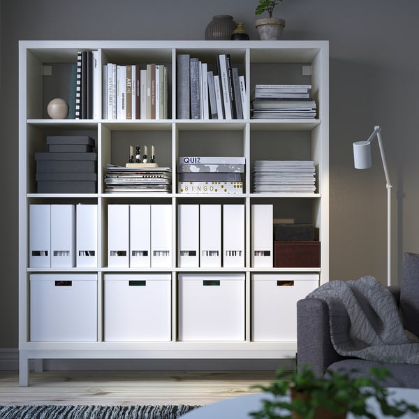 KALLAX white shelving unit stores books, boxes & decor. Tall, rectangular, airy design, fits large room.