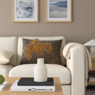 KAPKASTANJ vase on table with branches, sofa, candle, books, nature art.