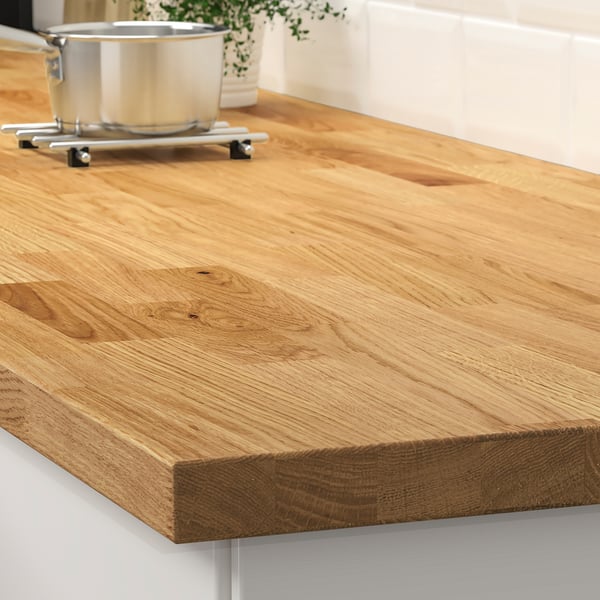 A wooden kitchen countertop, providing a durable and attractive surface for food preparation.