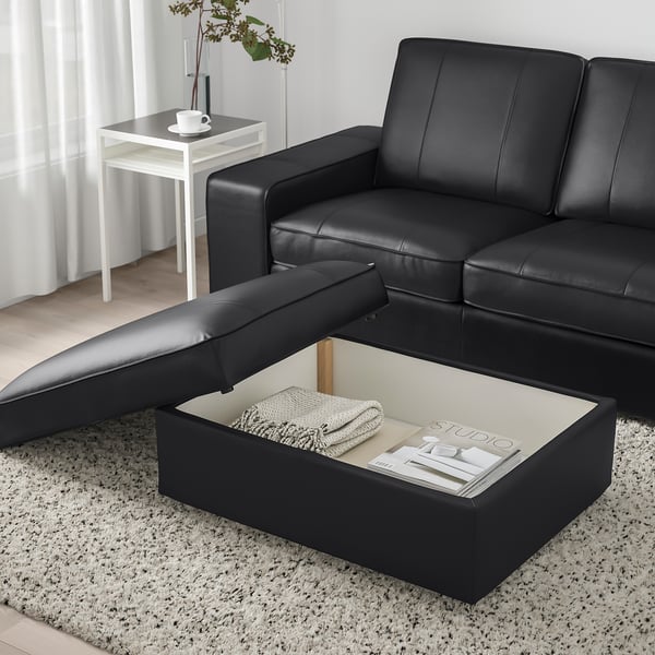 Modern living room with KIVIK sofa, footstool, coffee table, and storage.
