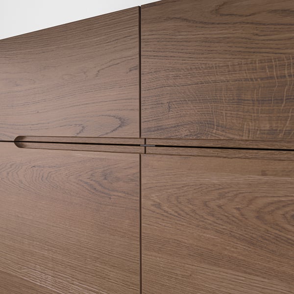 Sleek oak veneer sideboard with smooth handles, showcasing top-quality craftsmanship and natural wood texture.
