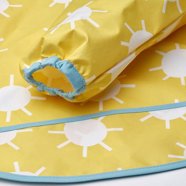 Yellow kids bib with white sun prints, light blue trim, and elastic cuffs. Soft and durable fabric.
