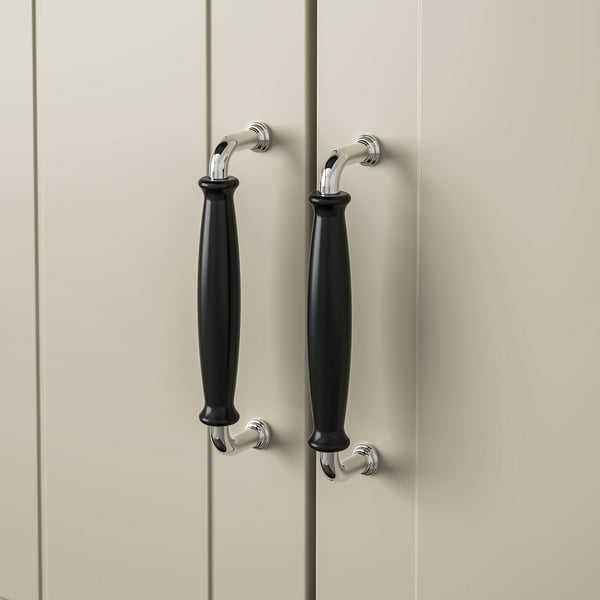 Modern kitchen cabinets with black handles and chrome accents.