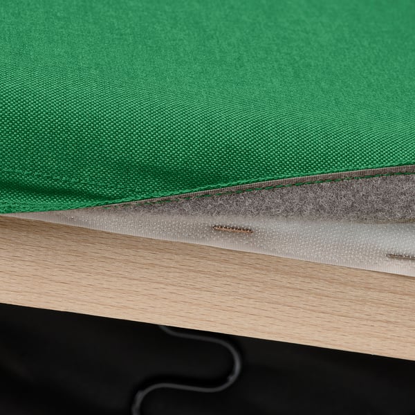 Green sofa cover with velcro attachment on wooden frame.