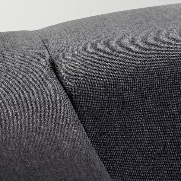 Close-up: modern sofa in dark grey fabric, showcasing smooth texture and neat stitching.