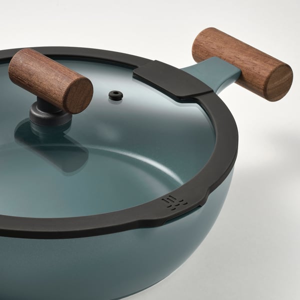 Non-stick turquoise sauté pan, glass lid, wood handles.