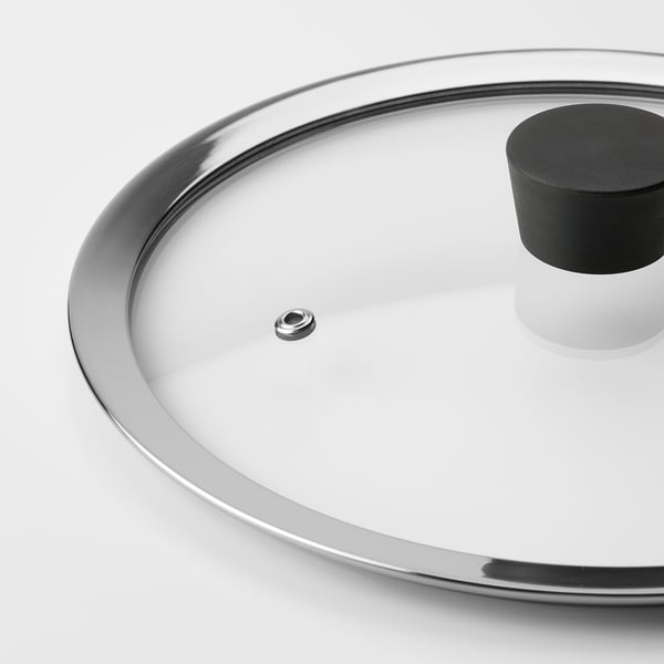Close-up of tempered glass lid, silver rim, black handle