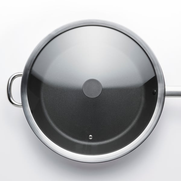 Top view of a stainless steel pan with glass lid. Lid has concave shape, fits 32cm pan.
