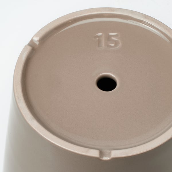 Top view of a light beige round planter with a small drainage hole and the number 15 embossed.