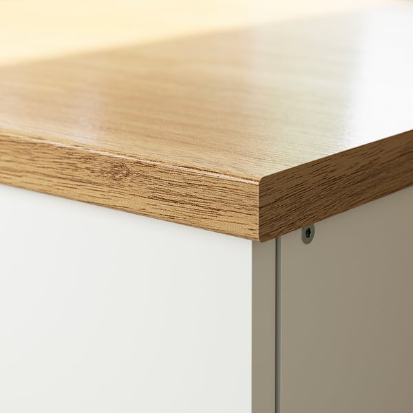 Wooden countertop with a smooth, light finish, seamlessly connected to white cabinets. The surface appears durable and easy to maintain.