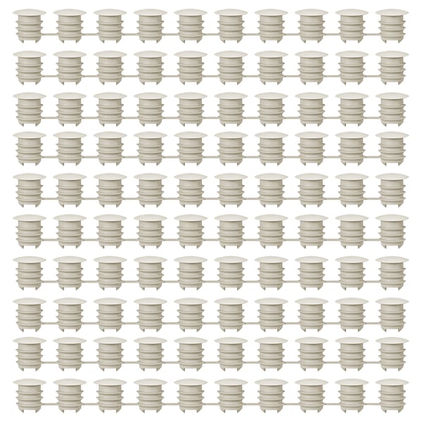Grid of white KOMPLEMENT plastic furniture cover caps, uniformly shaped and aligned.