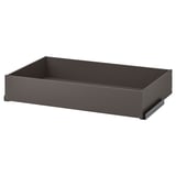 A grey KOMPLEMENT drawer for organising clothes. Its rectangular with smooth edges and a dark, minimalist finish.
