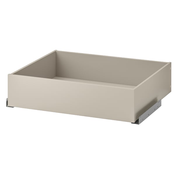 The KOMPLEMENT drawer in beige with a smooth finish, ideal for storing clothes or accessories. It has a rectangular shape and soft-closing mechanism.