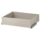 The KOMPLEMENT drawer in beige with a smooth finish, ideal for storing clothes or accessories. It has a rectangular shape and soft-closing mechanism.