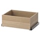 An IKEA KOMPLEMENT drawer in light oak colour, made of particle board and fiberboard, designed for organising clothes and accessories.