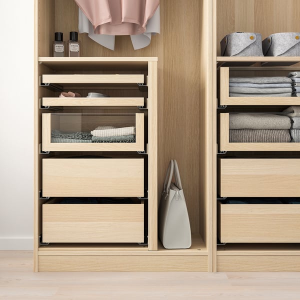 Modern closet with glass-front drawers, showing organised clothes and accessories.