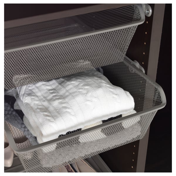 Mesh basket holds folded clothes, allows air circulation, keeping items fresh.