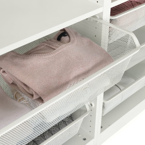 Mesh basket storing folded clothes, allowing air circulation and easy visibility. Part of IKEAs KOMPLEMENT series.