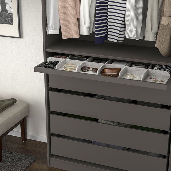 Closet organiser with pull-out tray holding jewellery and accessories, plus hangers and shelves above.