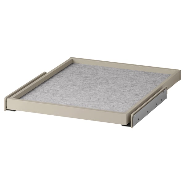 A beige KOMPLEMENT pull-out tray with a grey drawer mat, designed for wardrobes, featuring a sleek and modern design.