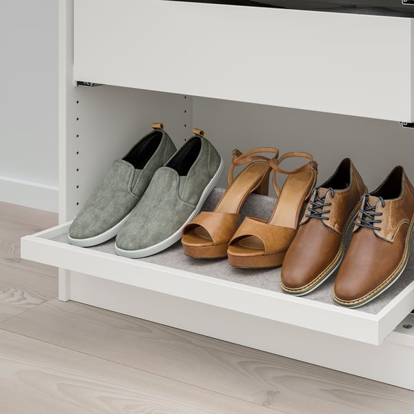 White shelf holding three pairs of shoes, including grey trainers, tan sandals, and brown lace-up shoes. Pull-out tray organises footwear neatly.