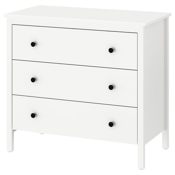 A white KOPPANG chest of drawers with three drawers and black knobs, made of fiberboard and particleboard, designed for safe wall anchorage.