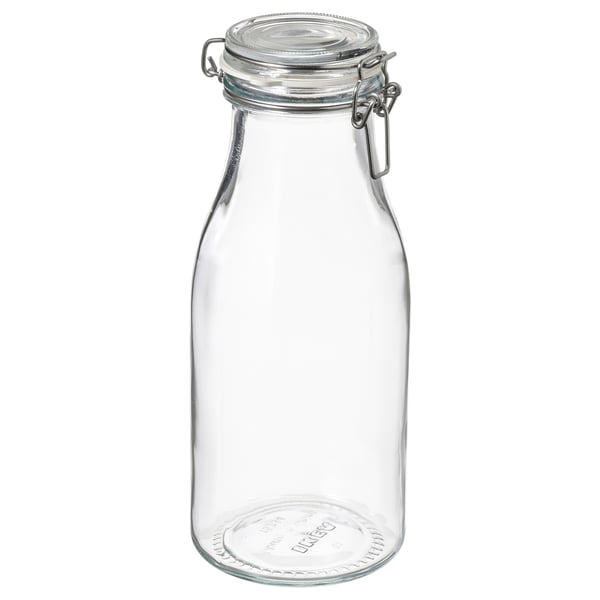 Clear glass jar with metal clamp lid, ideal for food storage. Transparent, cylindrical with a flat bottom.