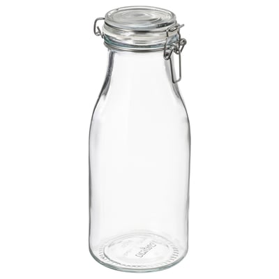 Clear glass jar with metal clamp lid, ideal for food storage. Transparent, cylindrical with a flat bottom.