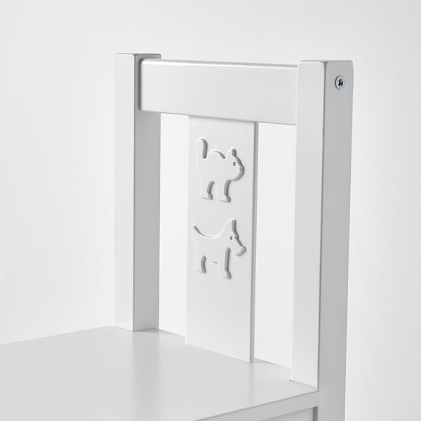 A sleek, white childrens chair made of sturdy materials, featuring decorative cutouts on the backrest.