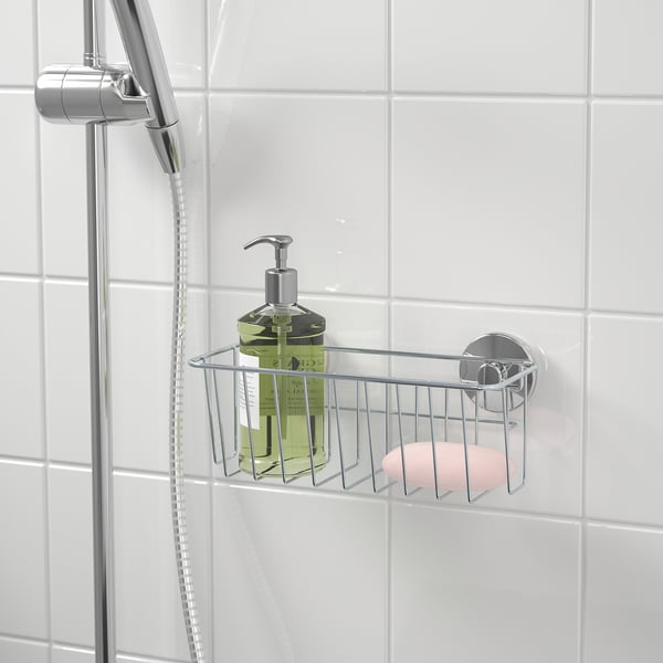 Metal shower basket holds soap and shampoo, attaches securely to tiled walls with suction cups.