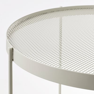 Round outdoor table with metal mesh surface, beige colour, sturdy design.